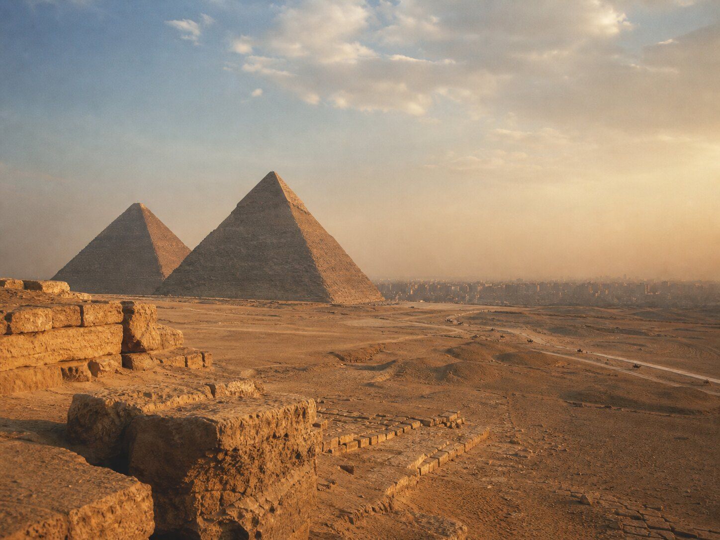 The Giza pyramids overlooking Cairo at golden hour